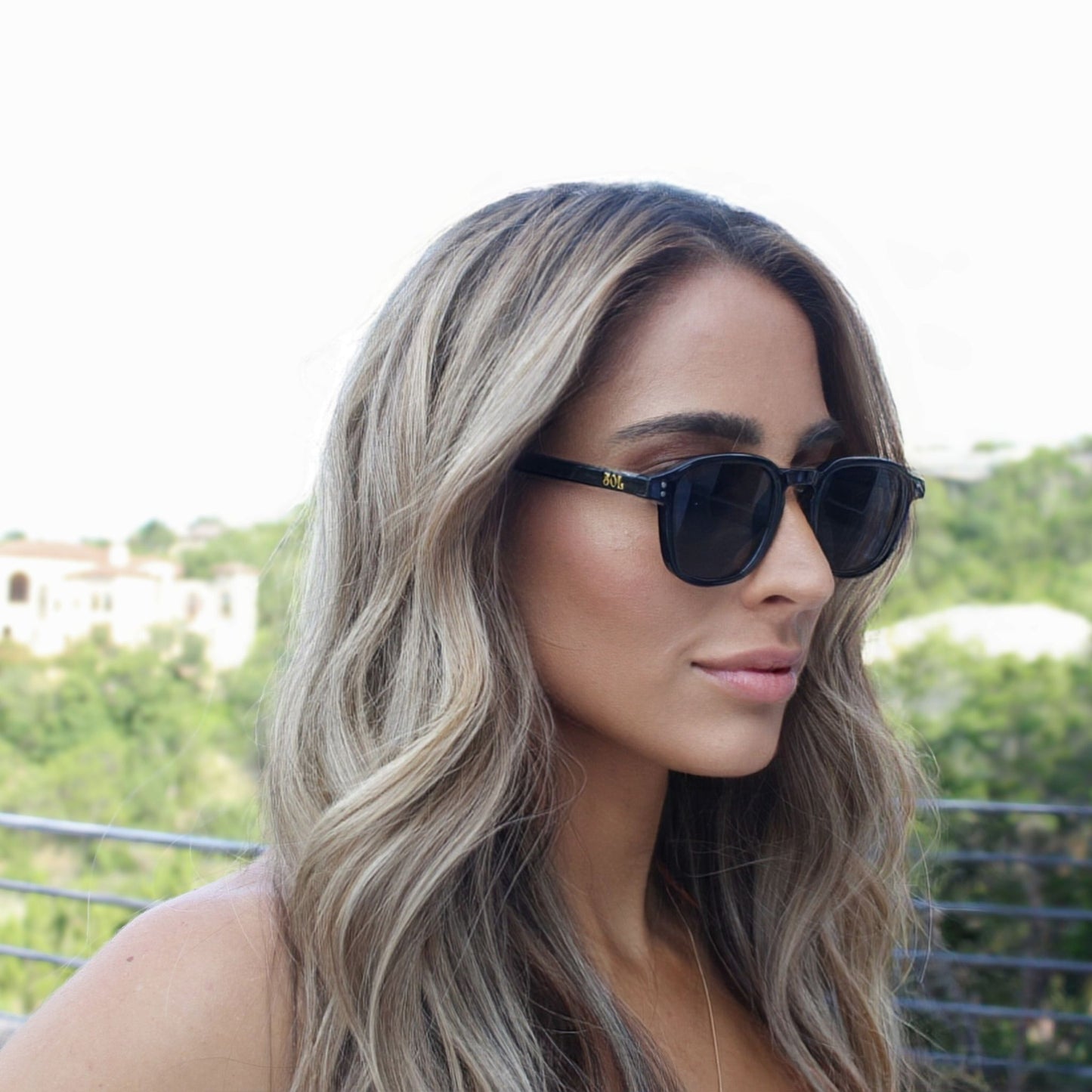 Female model wearing Banks - Black square shaped sunglasses with black lenses
